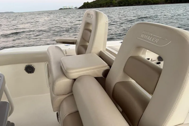  Yacht Photos Pics 2017 Boston Whaler 330 Outrage boat seats with ocean view in the background.