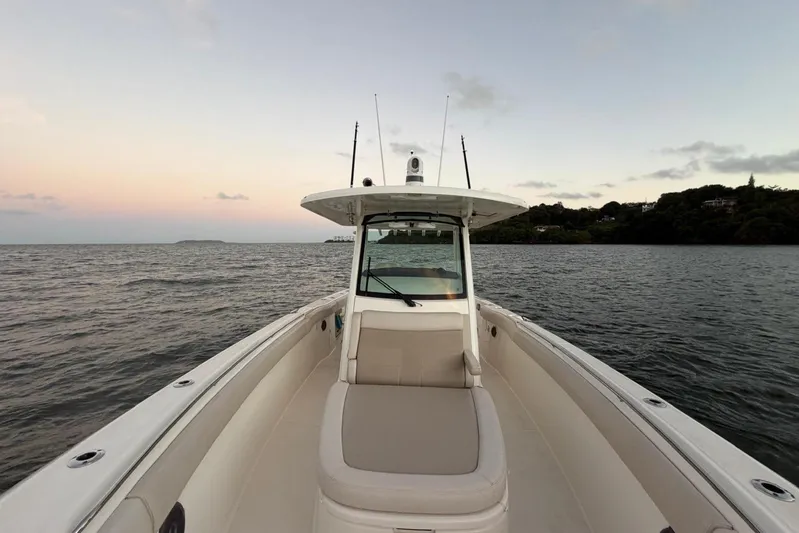  Yacht Photos Pics Boston Whaler 330 Outrage 2017 boat on calm waters at sunset.