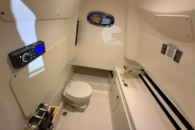  Yacht Photos Pics 2017 Boston Whaler 330 Outrage cabin interior with toilet and sink.