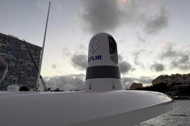  Yacht Photos Pics FLIR camera on 2017 Boston Whaler 330 Outrage boat at sunset, with buildings in background.
