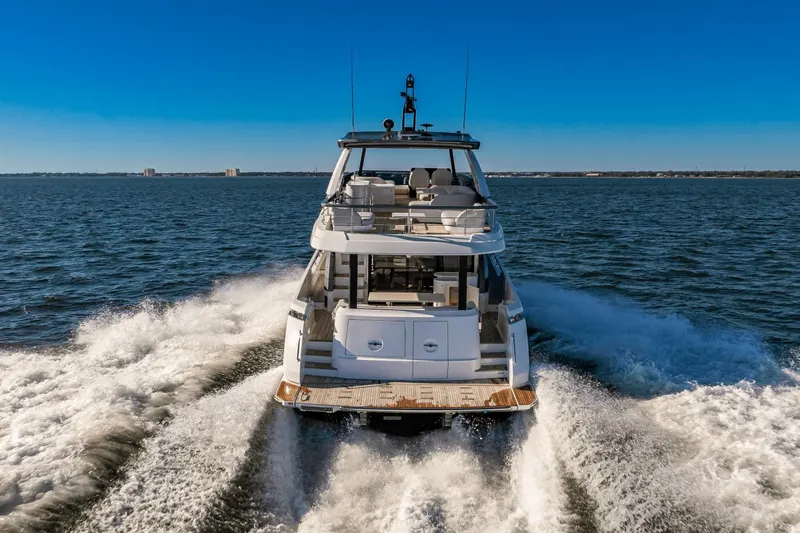  Yacht Photos Pics 2024 Azimut 68 yacht cruising on open water under clear blue skies.