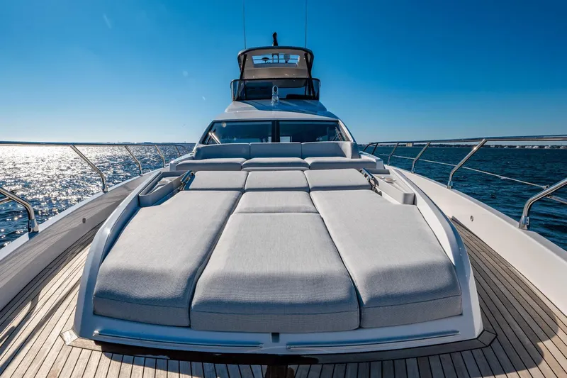  Yacht Photos Pics 2024 Azimut 68 yacht with sun loungers on deck, cruising on open water.