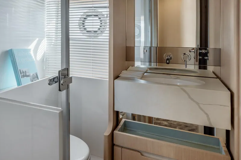  Yacht Photos Pics Luxurious bathroom in 2024 Azimut 68 yacht with modern fixtures and sleek design.