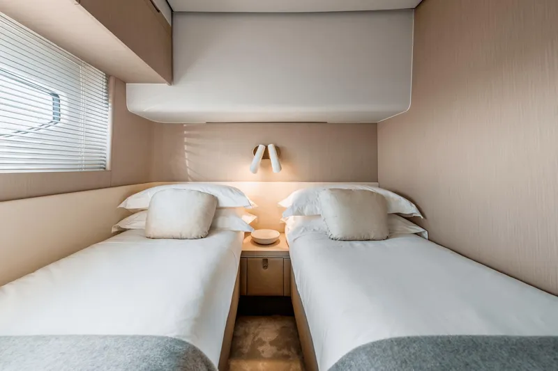  Yacht Photos Pics Luxurious twin bedroom in 2024 Azimut 68 yacht, featuring modern design and cozy ambiance.