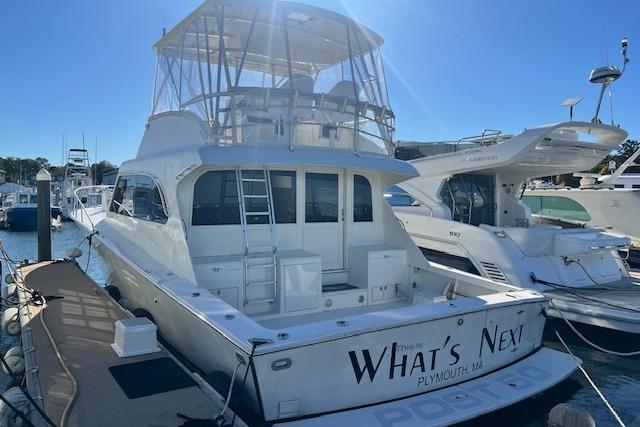 1995 Post 50 Convertible yacht docked, featuring spacious deck and flybridge, named "What's Next."