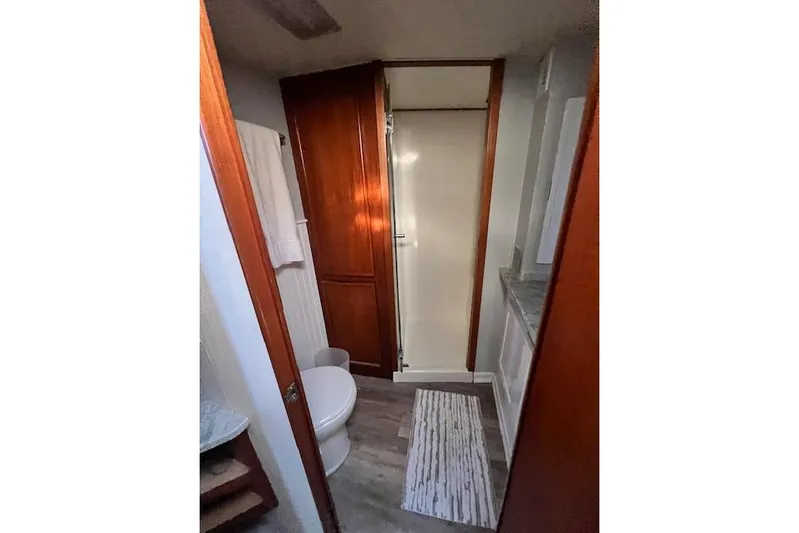 What's Next Yacht Photos Pics Bathroom interior of a 1995 Post 50 Convertible yacht with wooden cabinetry and shower.
