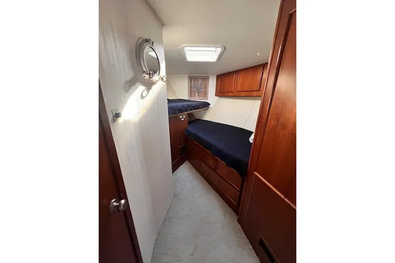 What's Next Yacht Photos Pics 1995 Post 50 Convertible yacht cabin with wooden interior and bunk beds.