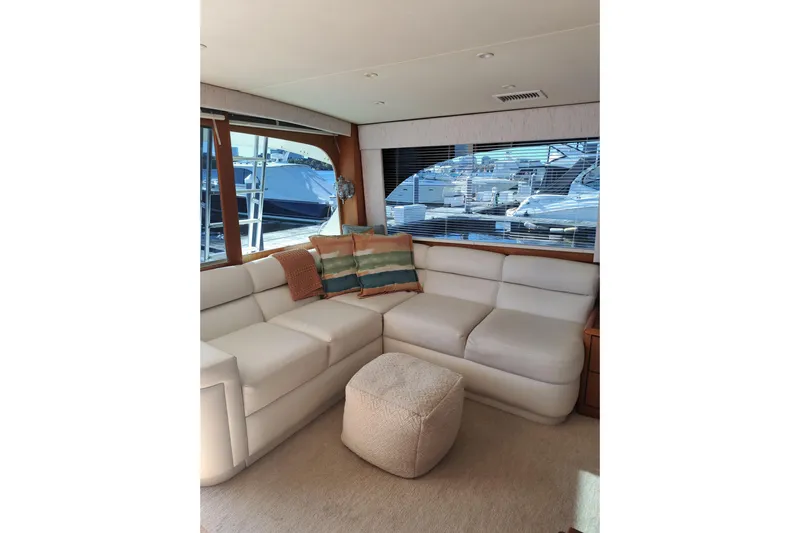 What's Next Yacht Photos Pics Luxurious interior of a 1995 Post 50 Convertible yacht with plush seating and large windows.