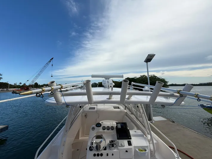 Yacht Photos Pics 2006 Intrepid 350 Center Console boat docked by a scenic waterfront.