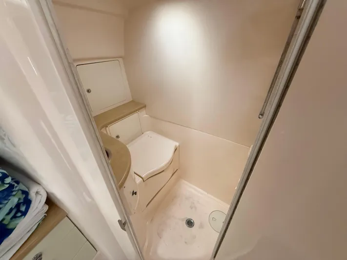  Yacht Photos Pics 2006 Intrepid 350 Center Console boat interior bathroom with compact design and storage.