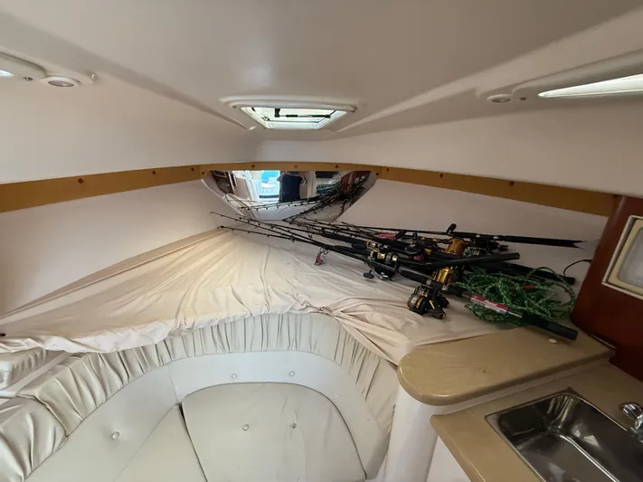  Yacht Photos Pics Interior cabin of a 2006 Intrepid 350 Center Console with fishing rods and a small sink.