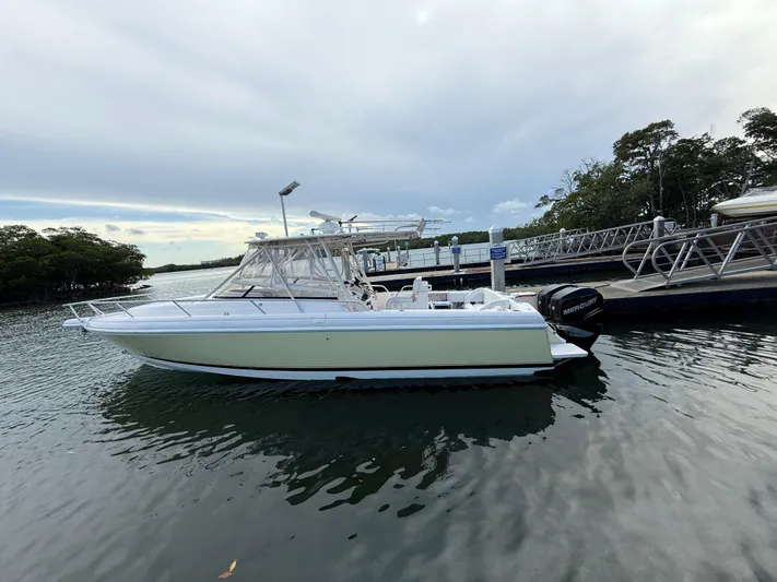  Yacht Photos Pics 2006 Intrepid 350 Center Console boat docked on calm water.