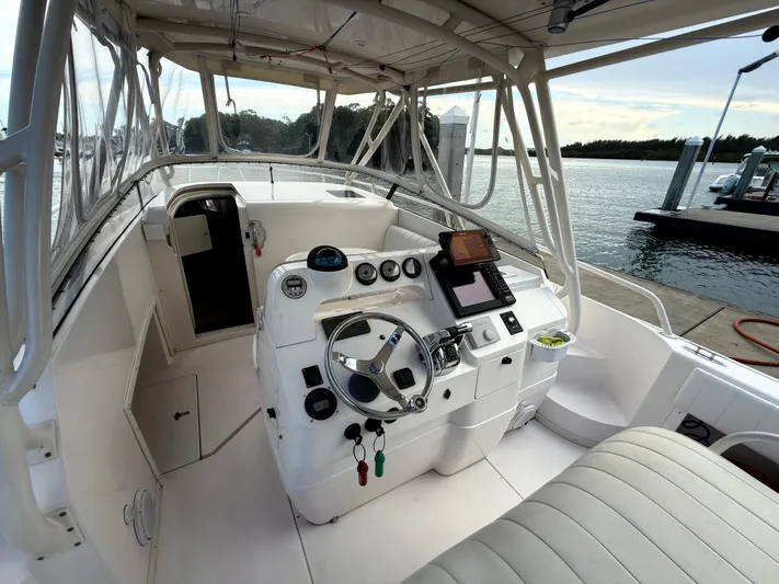  Yacht Photos Pics 2006 Intrepid 350 Center Console boat interior with steering wheel and navigation equipment.