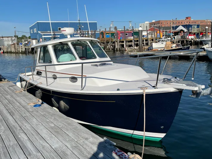 Halcyon Yacht Photos Pics 2006 Back Cove 29 boat docked at a marina, blue hull, clear sky.