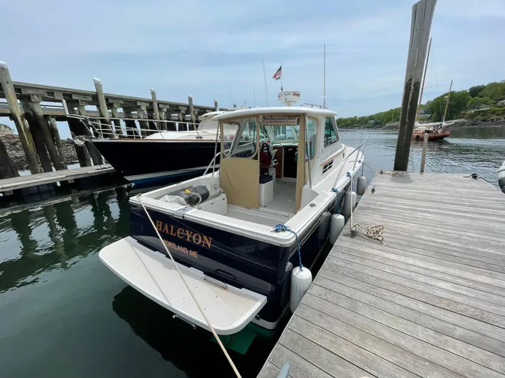 Halcyon Yacht Photos Pics 2006 Back Cove 29 boat docked at a marina, named "Halcyon," Portland, ME.