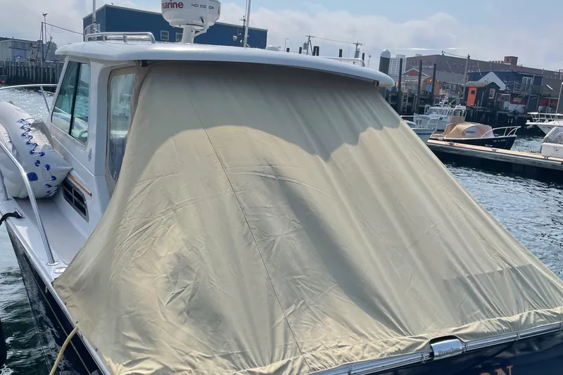 Halcyon Yacht Photos Pics 2006 Back Cove 29 boat with beige cover docked at marina.