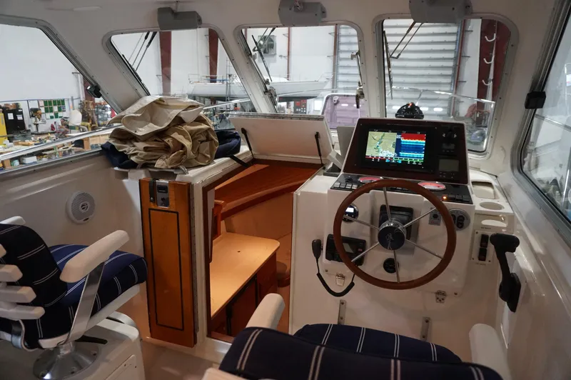 Halcyon Yacht Photos Pics 2006 Back Cove 29 boat interior with navigation equipment and seating.