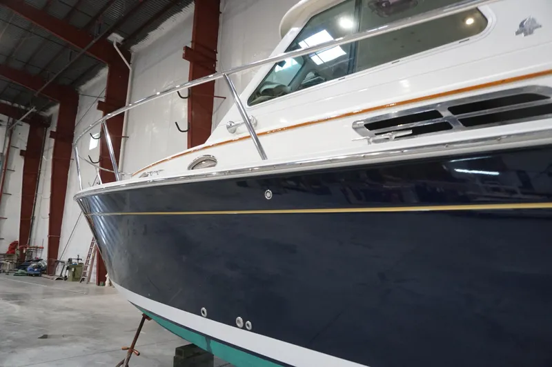 Halcyon Yacht Photos Pics 2006 Back Cove 29 boat in a warehouse, showcasing sleek design and craftsmanship.