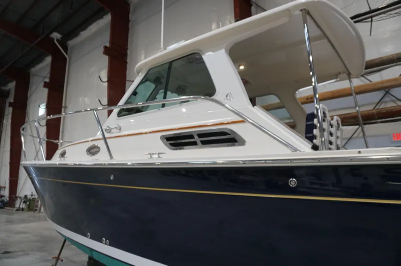 Halcyon Yacht Photos Pics 2006 Back Cove 29 boat in a warehouse, showcasing sleek design and sturdy build.