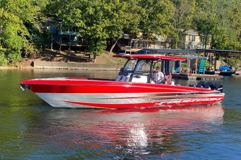  Yacht Photos Pics 2021 Fountain 34 SC boat in vibrant red on a serene lake.