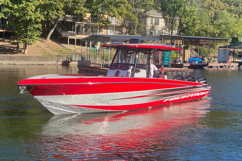  Yacht Photos Pics 2021 Fountain 34 SC boat in vibrant red on a serene lake.