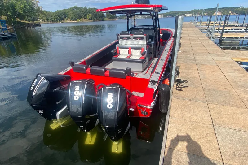  Yacht Photos Pics 2021 Fountain 34 SC boat docked, featuring triple Mercury 300 engines, vibrant red design.