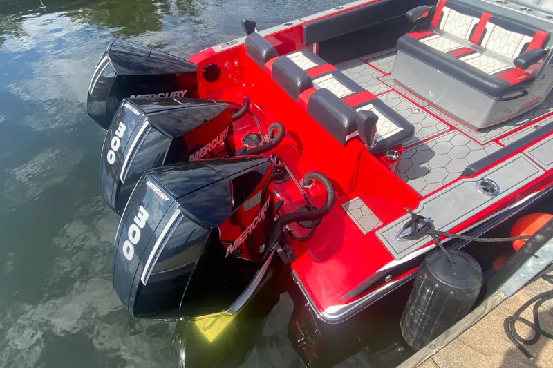 Yacht Photos Pics Red 2021 Fountain 34 SC boat with triple Mercury 300 engines docked on water.