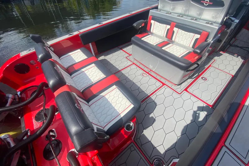  Yacht Photos Pics 2021 Fountain 34 SC boat interior with red and white seating, hexagonal flooring, and cup holders.