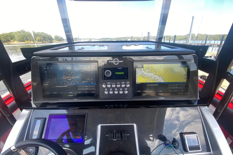  Yacht Photos Pics 2021 Fountain 34 SC boat dashboard with dual Garmin displays and navigation controls.
