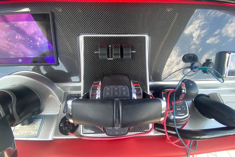  Yacht Photos Pics Control panel of 2021 Fountain 34 SC boat with carbon fiber finish and digital display.