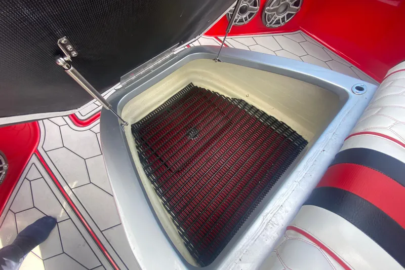  Yacht Photos Pics Open storage compartment in 2021 Fountain 34 SC boat interior, featuring red and black accents.