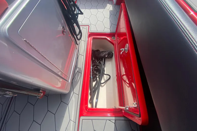  Yacht Photos Pics 2021 Fountain 34 SC boat storage compartment with ropes, red and gray interior.