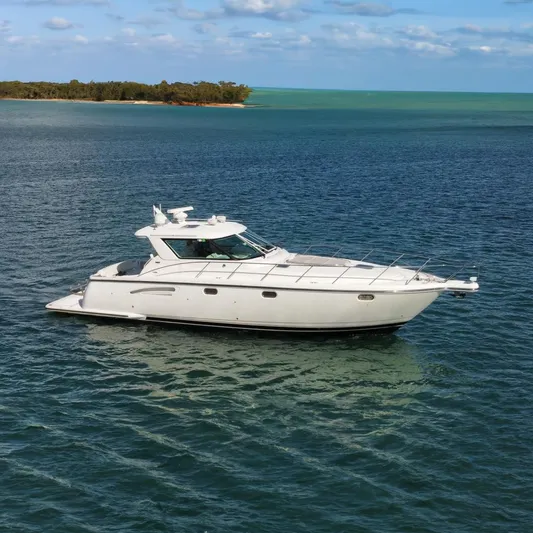 Family Bonds Yacht Photos Pics 2005 Tiara Yachts 4400 Sovran cruising on open water.