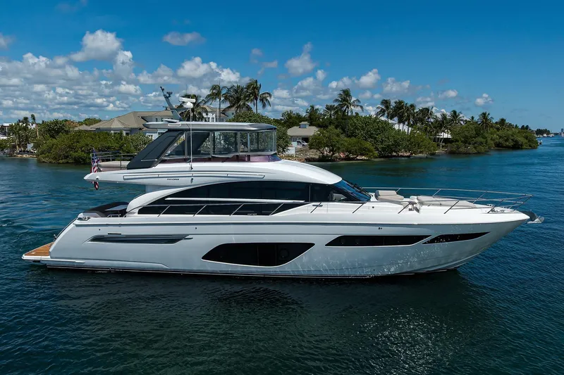 Miss Amy Yacht Photos Pics Luxurious 2020 Princess F70 yacht cruising on a sunny day, surrounded by tropical scenery.
