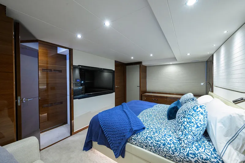 Miss Amy Yacht Photos Pics Luxurious 2020 Princess F70 yacht bedroom with elegant blue bedding and modern decor.