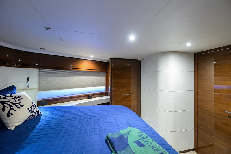 Miss Amy Yacht Photos Pics Luxurious cabin interior of 2020 Princess F70 yacht with blue bedding and modern design.