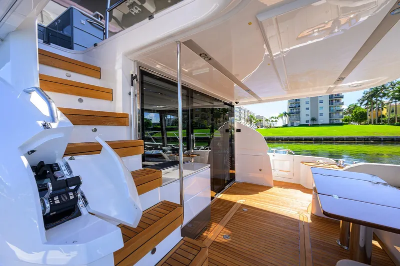 Miss Amy Yacht Photos Pics Luxurious 2020 Princess F70 yacht interior with wooden stairs and outdoor seating area.