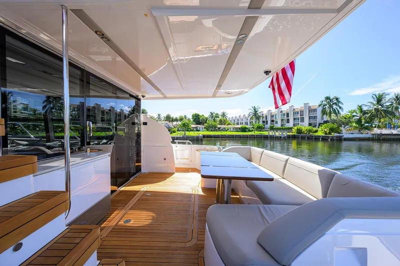 Miss Amy Yacht Photos Pics Luxurious 2020 Princess F70 yacht deck with seating, table, and waterfront view.