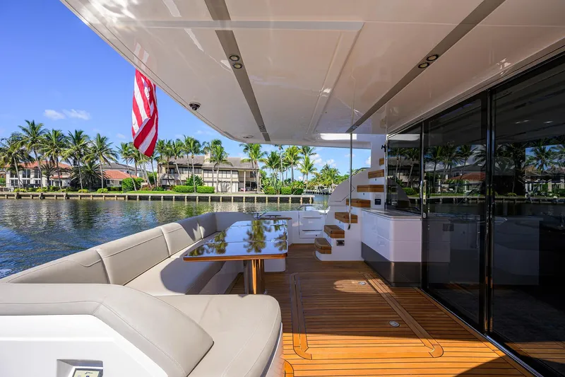 Miss Amy Yacht Photos Pics Luxurious 2020 Princess F70 yacht deck with seating, table, and waterfront view.