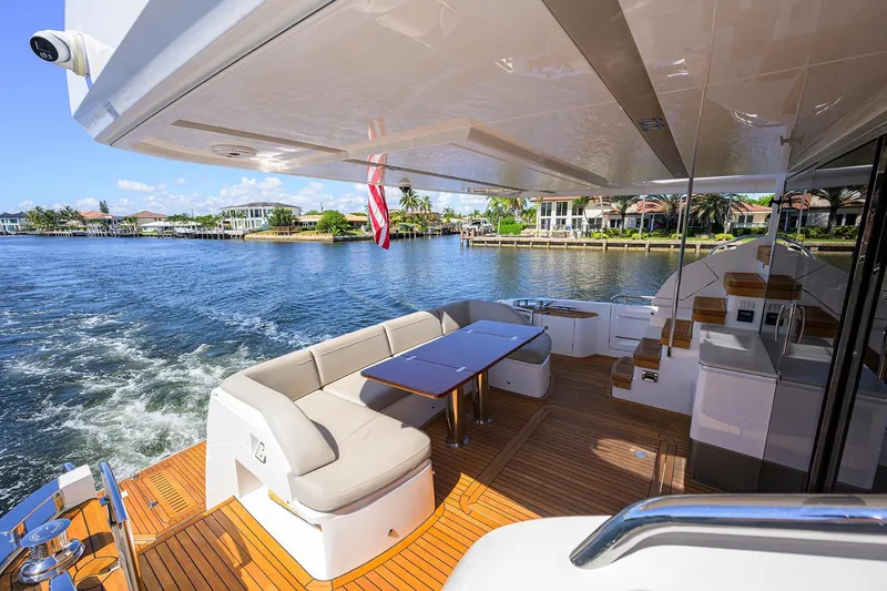 Miss Amy Yacht Photos Pics Luxurious 2020 Princess F70 yacht deck with elegant seating and scenic waterfront view.