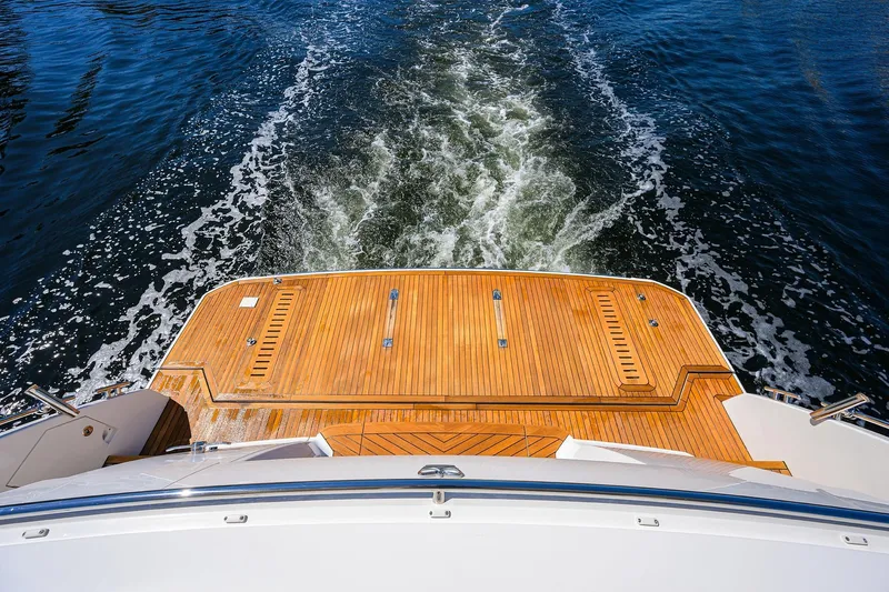 Miss Amy Yacht Photos Pics Rear view of 2020 Princess F70 yacht with teak deck and ocean wake.