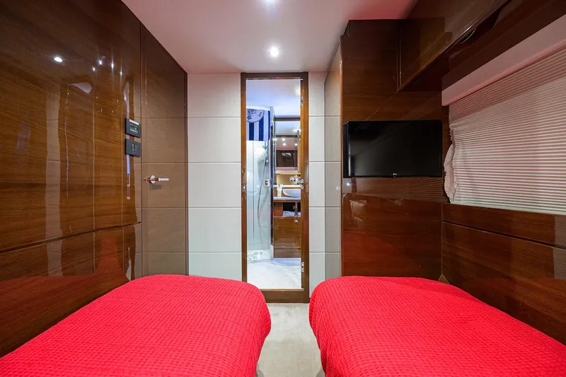 Miss Amy Yacht Photos Pics Luxurious 2020 Princess F70 yacht cabin with twin beds, red bedding, and modern decor.