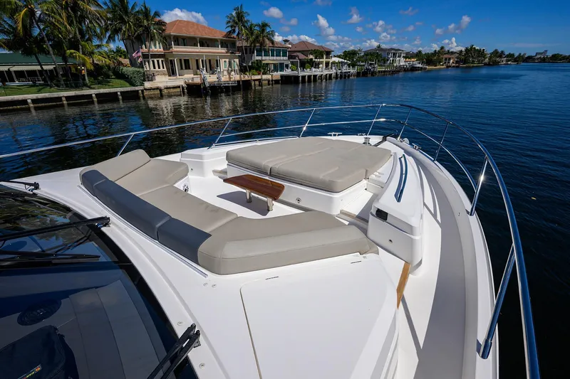 Miss Amy Yacht Photos Pics Luxurious 2020 Princess F70 yacht with spacious deck seating, docked by waterfront homes.