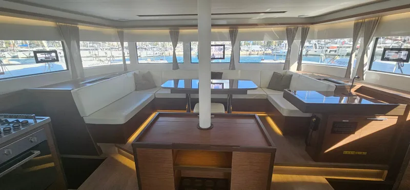  Yacht Photos Pics Luxurious interior of 2022 Lagoon 50 catamaran with spacious seating and panoramic windows.