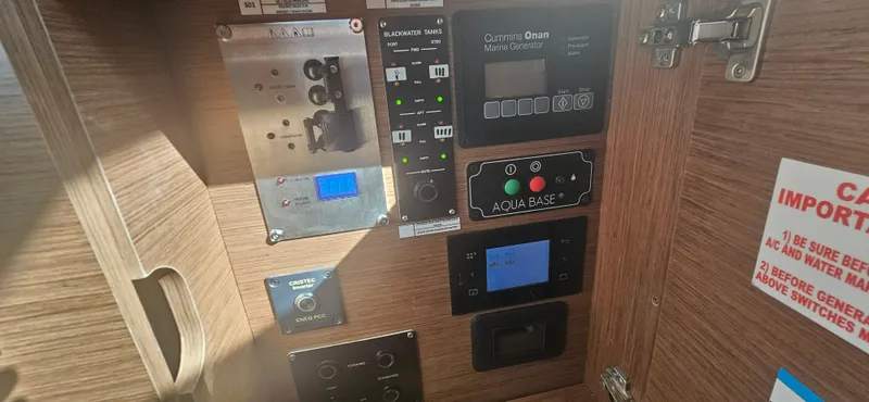  Yacht Photos Pics Control panel inside a 2022 Lagoon 50 yacht, featuring various electronic displays and switches.