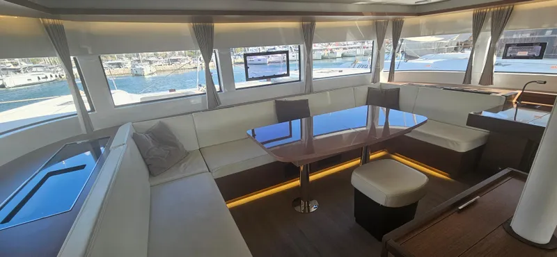  Yacht Photos Pics Luxurious interior of a 2022 Lagoon 50 yacht with elegant seating and panoramic windows.