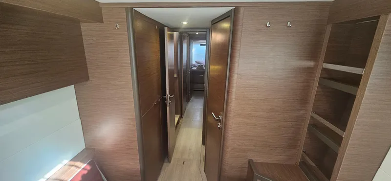  Yacht Photos Pics Interior of 2022 Lagoon 50 yacht with wooden finishes and hallway view.