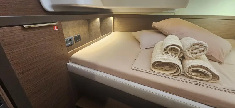  Yacht Photos Pics Luxurious cabin interior of 2022 Lagoon 50 yacht with neatly arranged towels.