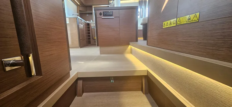  Yacht Photos Pics Interior of 2022 Lagoon 50 yacht, featuring wooden steps and ambient lighting.