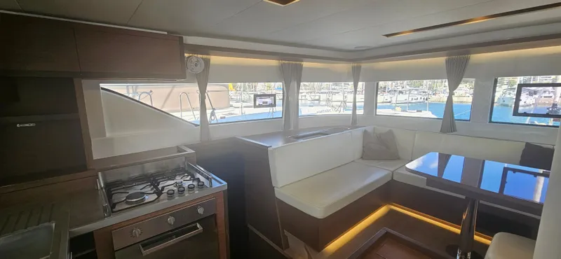  Yacht Photos Pics Interior of 2022 Lagoon 50 yacht with modern kitchen and seating area.